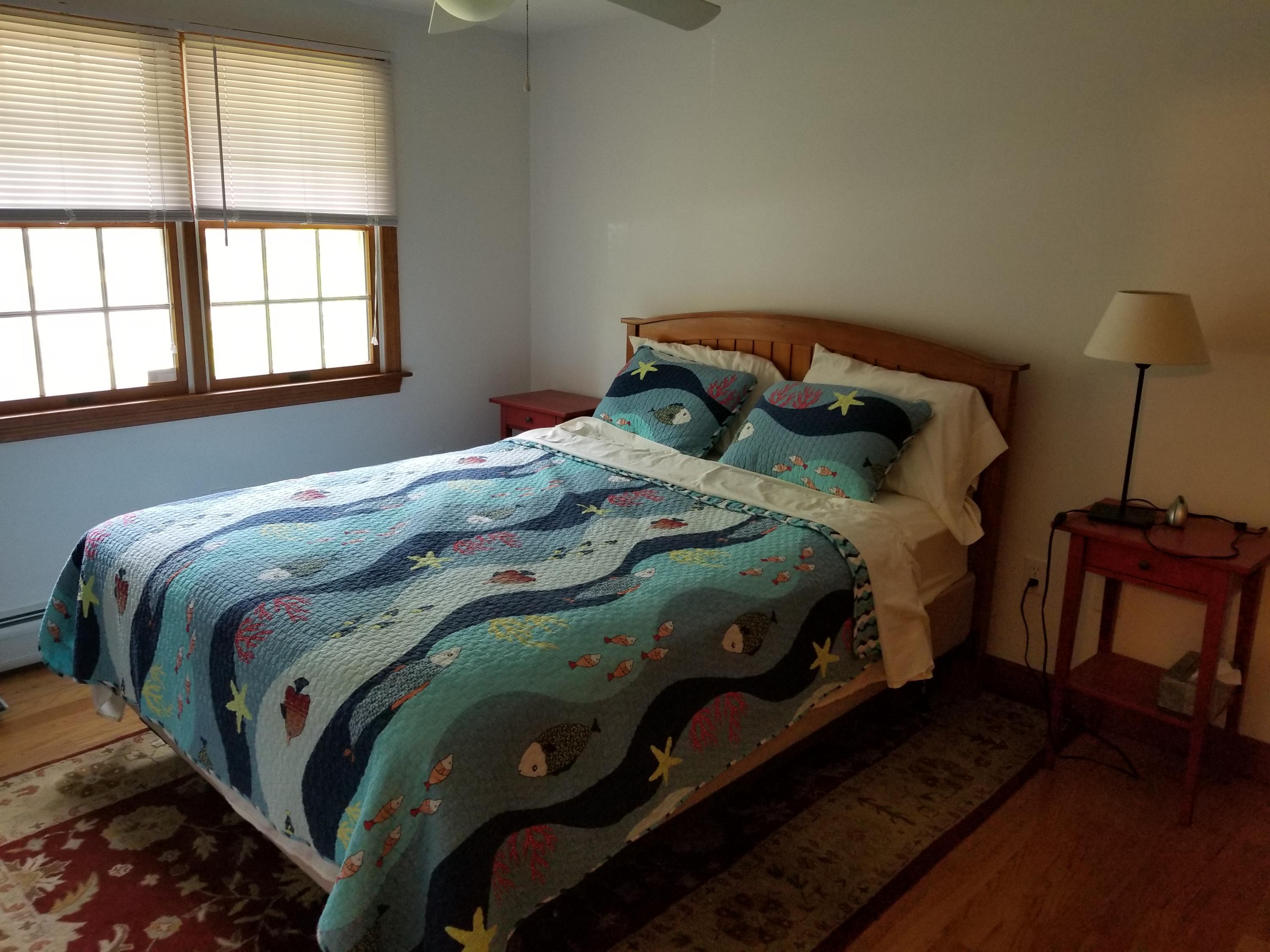 50 Nearmeadows Road West Yarmouth, MA 02673 - Photo 13 of 20 a bedroom with a bed and wooden floor