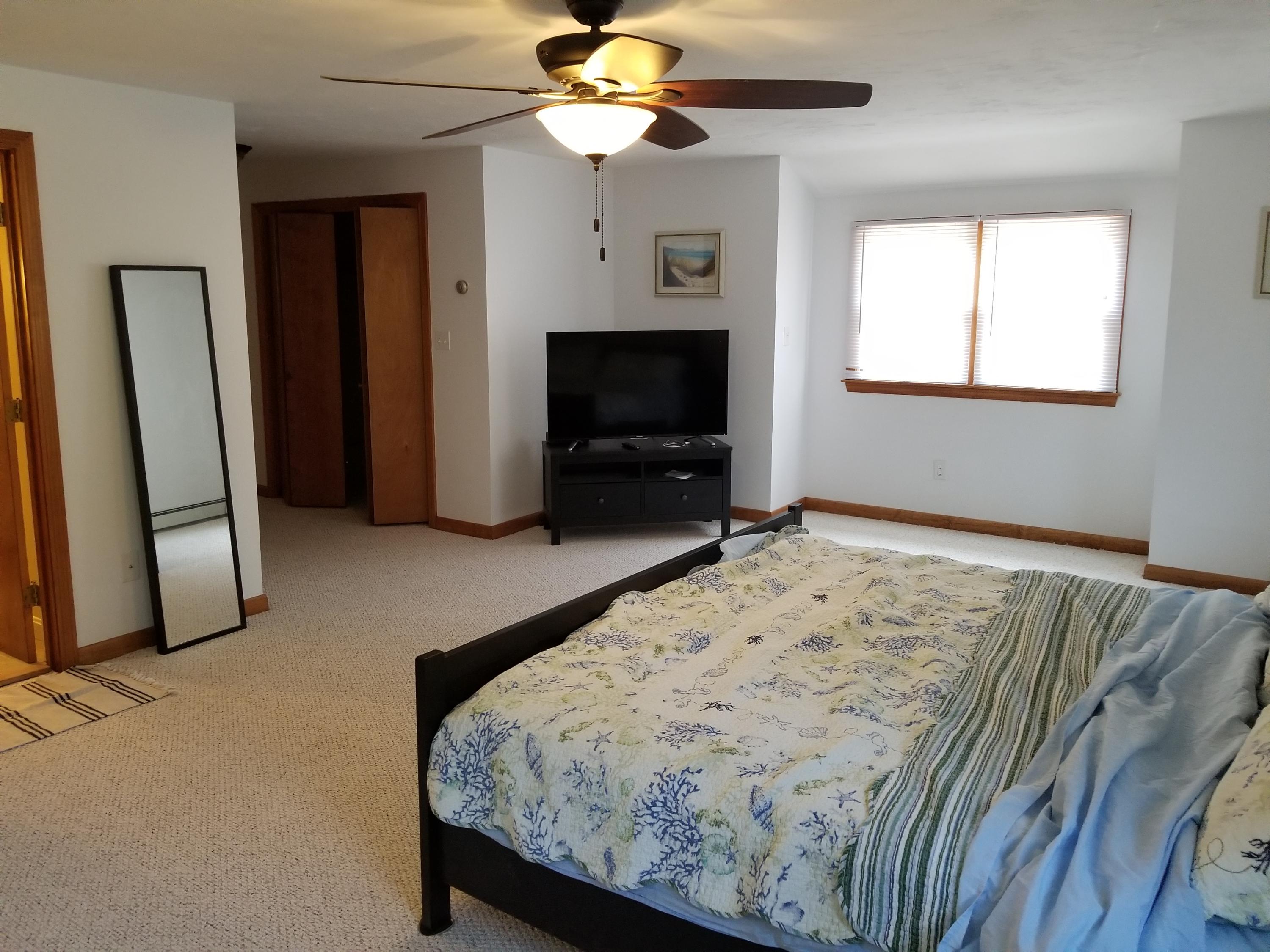 50 Nearmeadows Road West Yarmouth, MA 02673 - Photo 15 of 20 a bedroom with a bed and a flat screen tv