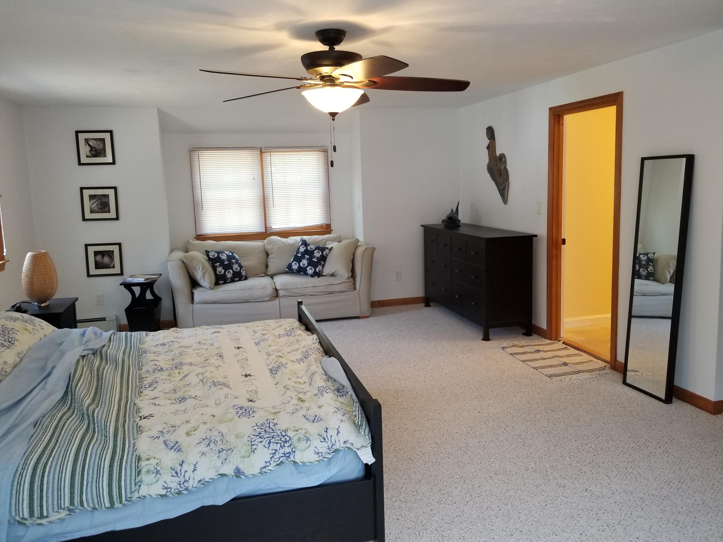 50 Nearmeadows Road West Yarmouth, MA 02673 - Photo 16 of 20 a bed room with a bed and a chandelier