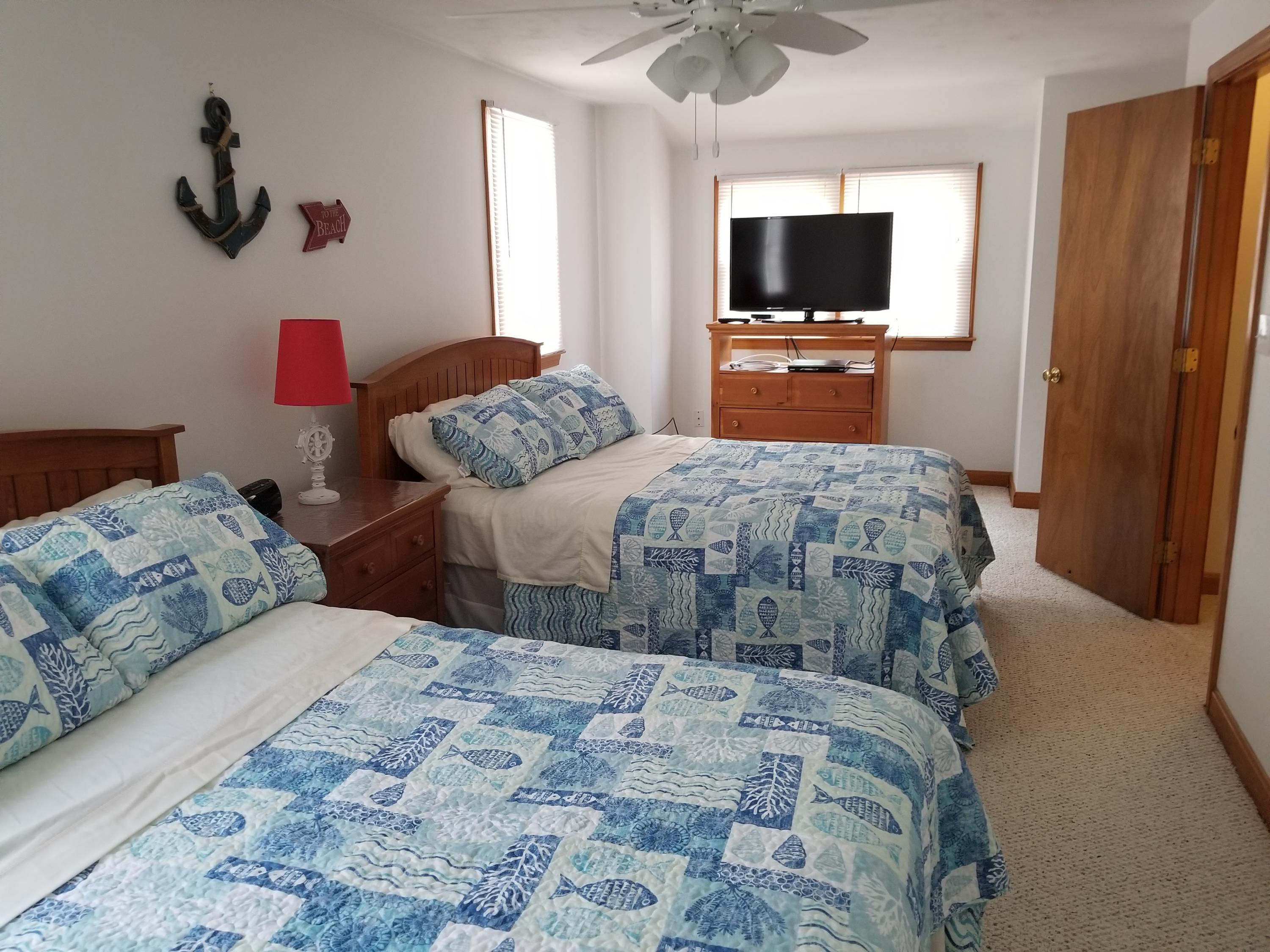 50 Nearmeadows Road West Yarmouth, MA 02673 - Photo 19 of 20 a bedroom with a bed and a flat screen tv