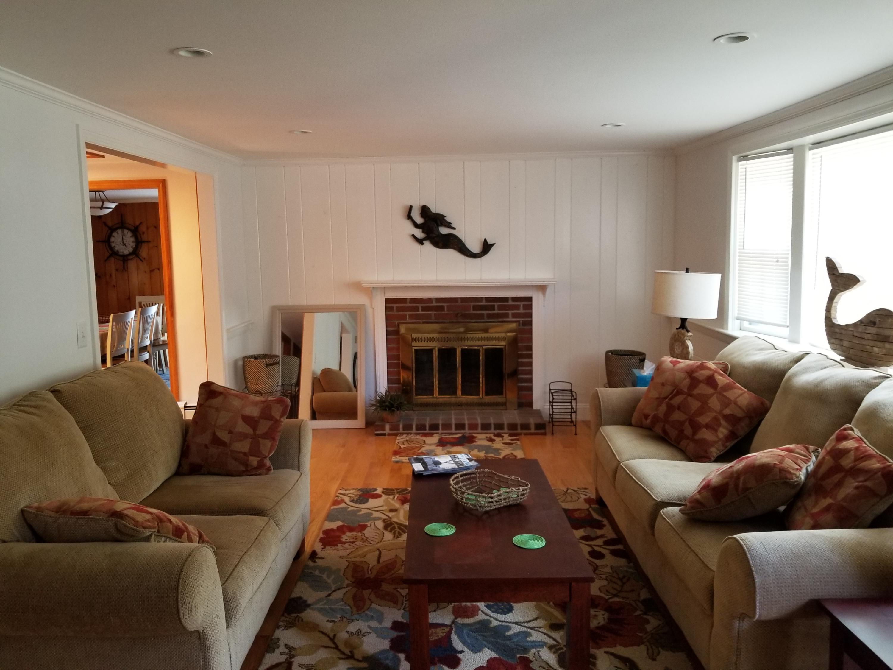 50 Nearmeadows Road West Yarmouth, MA 02673 - Photo 2 of 20 a living room with furniture and a fireplace