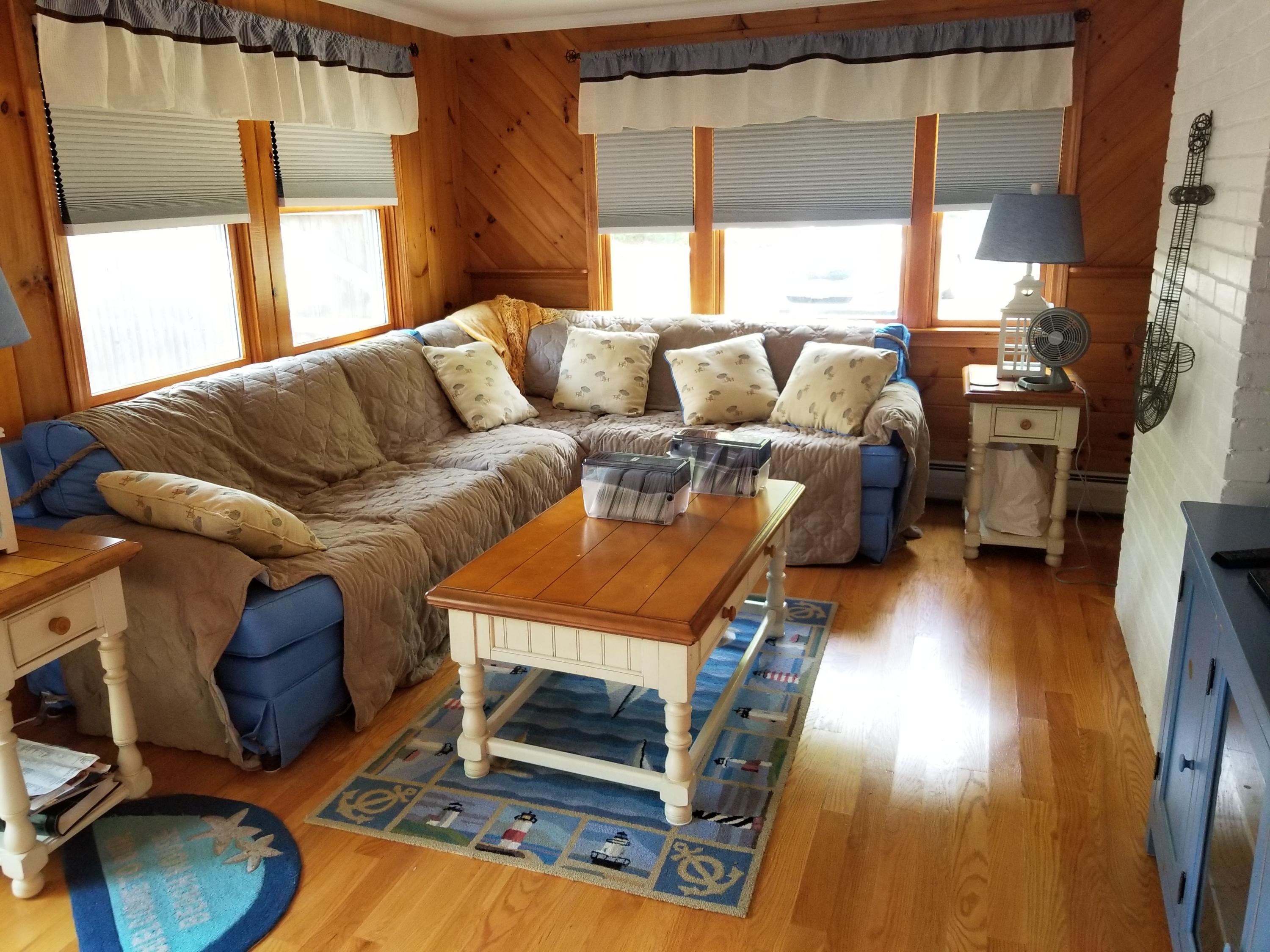 50 Nearmeadows Road West Yarmouth, MA 02673 - Photo 4 of 20 a living room with furniture a fireplace and a floor to ceiling window