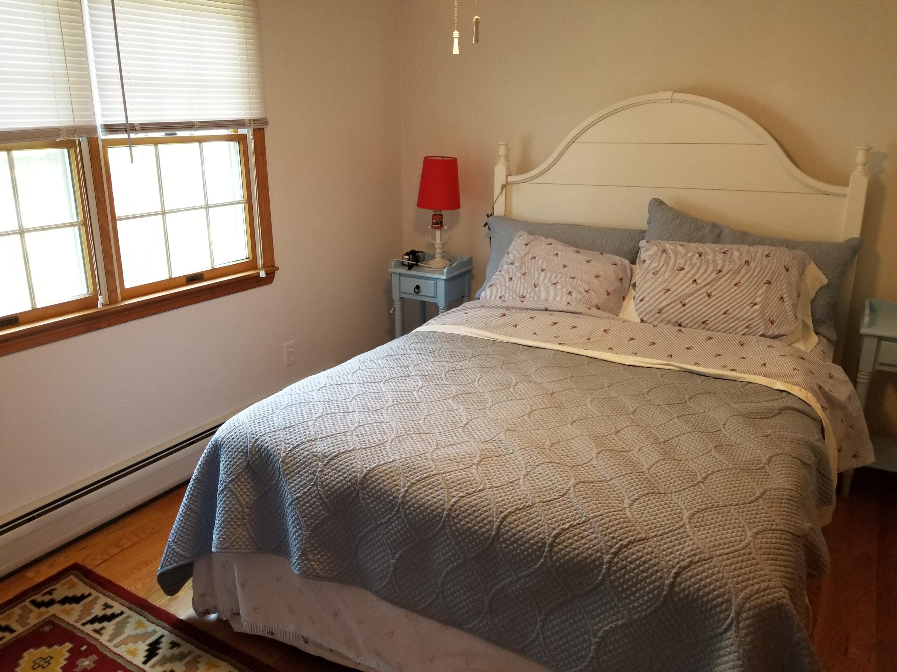 50 Nearmeadows Road West Yarmouth, MA 02673 - Photo 10 of 20 a bedroom with a bed and wooden floor
