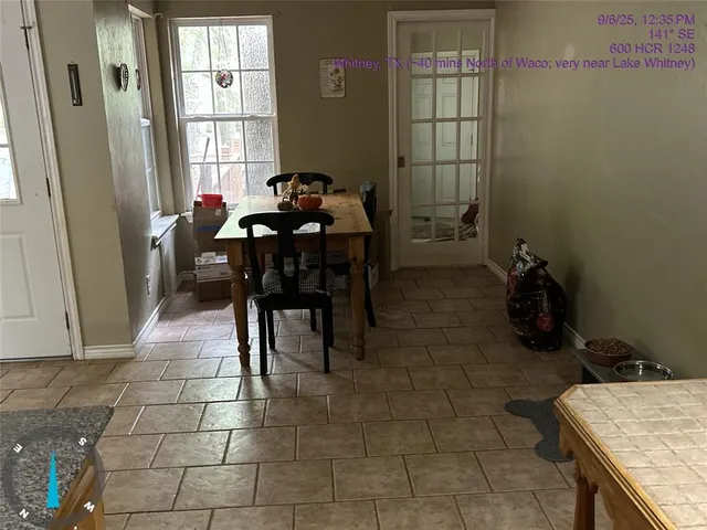 a dining room with furniture and window