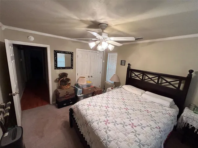 a bedroom with double bed and a chandelier