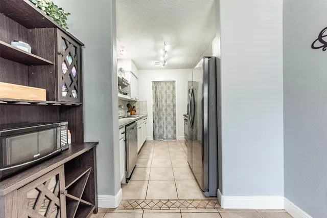 a view of a kitchen from the hallway