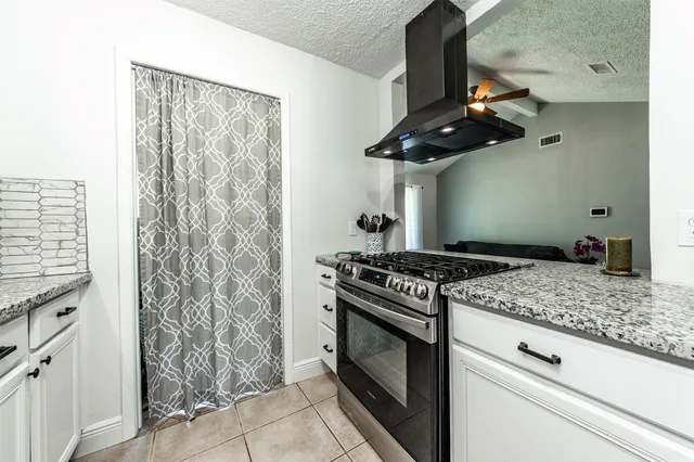 a kitchen with stainless steel appliances granite countertop a stove and a microwave