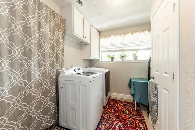 a utility room with a sink a washer and dryer