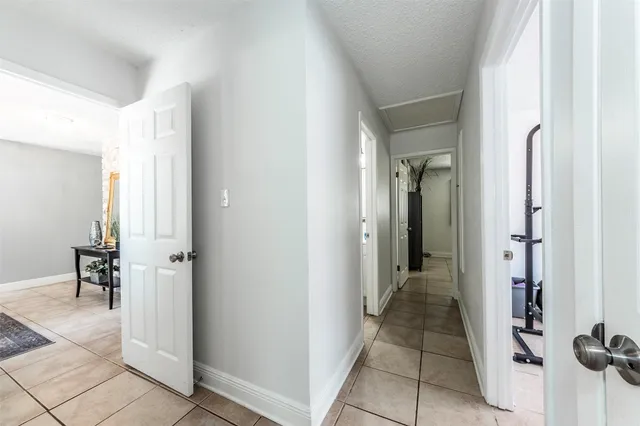 a view of a hallway with living room and dining room