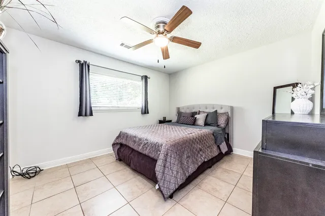 a spacious bedroom with a bed and window