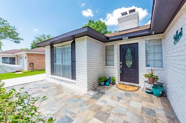 a front view of a house with swimming pool and sitting area
