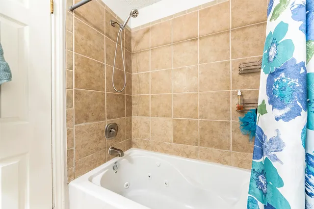 a white bath tub and shower