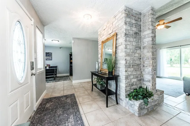 a hallway with a dining table and chairs