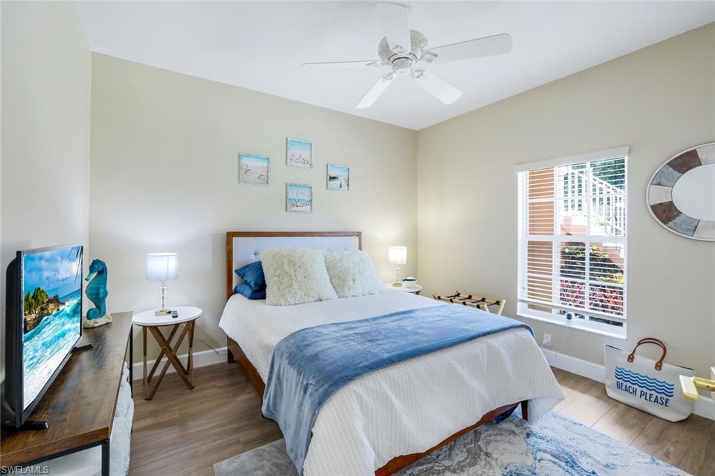 555 Augusta Boulevard, Unit 31 Naples, FL 34113 - Photo 12 of 17 Bedroom with baseboards, wood finished floors, and ceiling fan