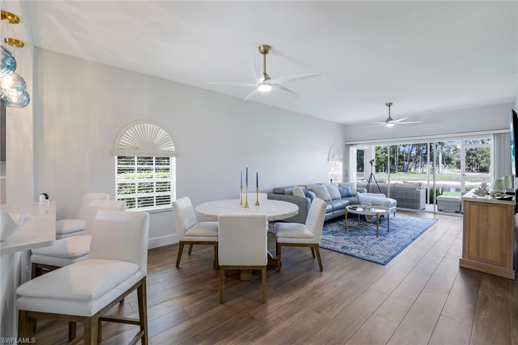 555 Augusta Boulevard, Unit 31 Naples, FL 34113 - Photo 4 of 17 Dining space featuring wood finished floors and ceiling fan
