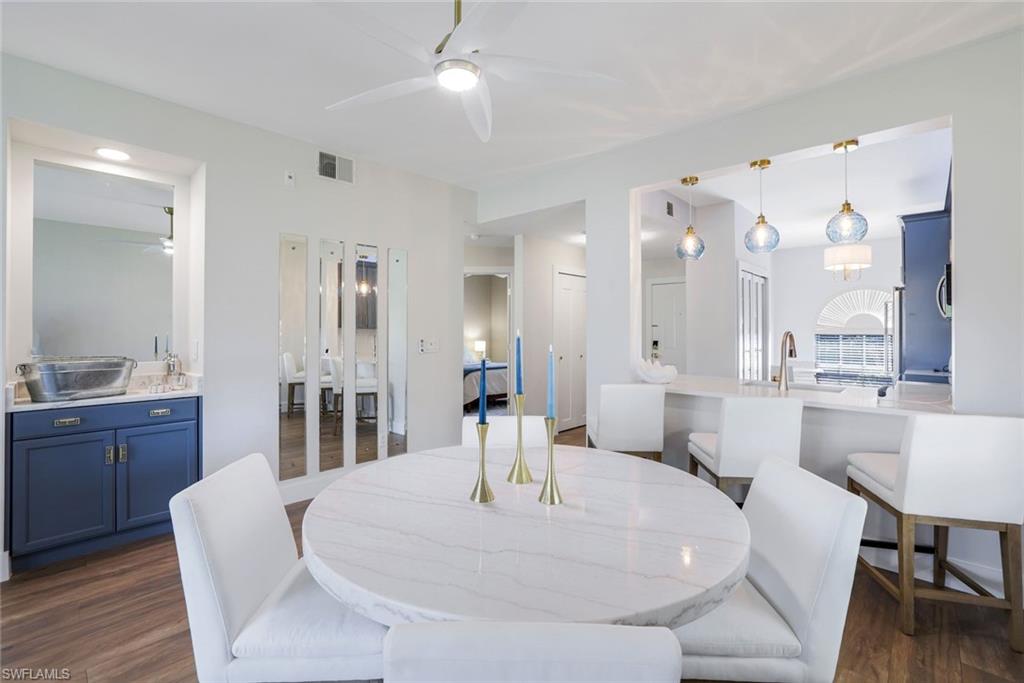 555 Augusta Boulevard, Unit 31 Naples, FL 34113 - Photo 5 of 17 Dining room with visible vents, ceiling fan, and dark wood-style flooring
