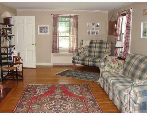 23 Bryant Road Cranston, RI 02910 - Photo 4 of 7 Living Room. spactious living room with fireplace, hardwoods, insulated windows tilt for easy cleaning, grids inside glass, can close this room off completely for privacy