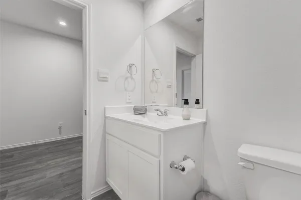 a bathroom with a sink a toilet and a mirror