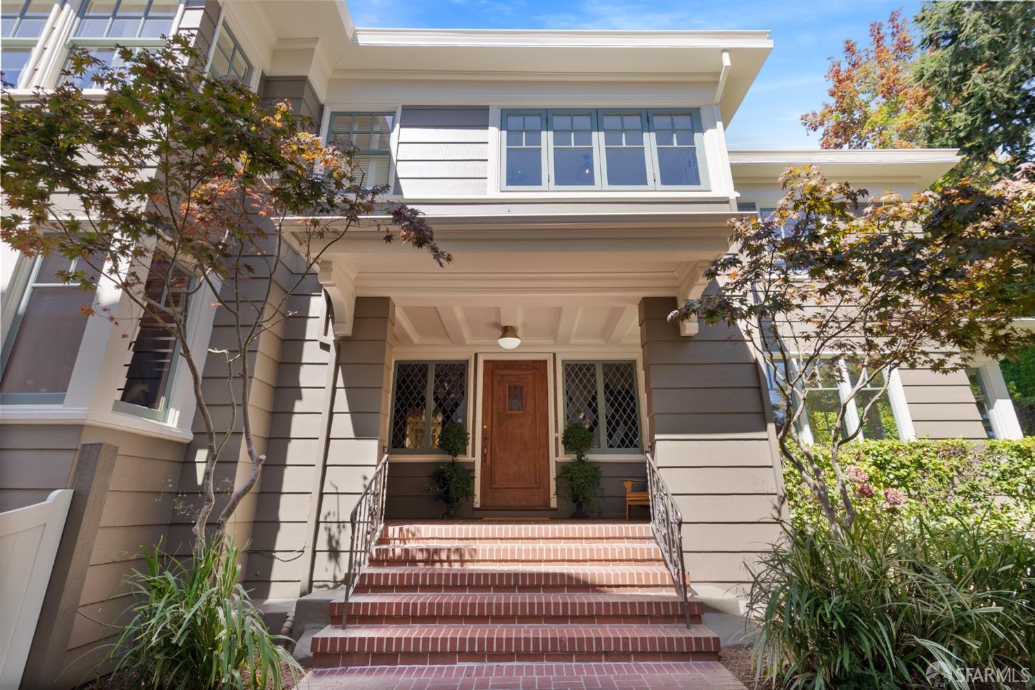 2728 Claremont Boulevard Berkeley, CA 94705 - Photo 2 of 55 a view of a brick house with large windows and flower plants