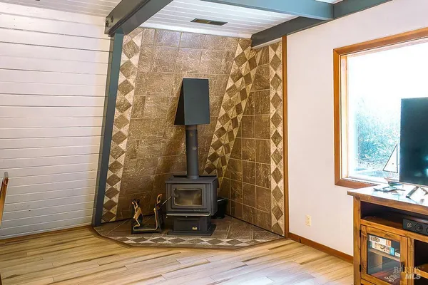 a view of water heater room with wooden floor