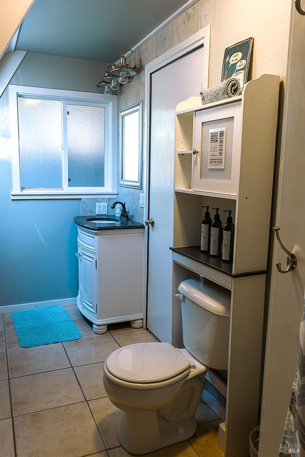 46151 Pacific Woods Road Gualala, CA 95445 - Photo 16 of 25 a bathroom with a toilet sink and mirror