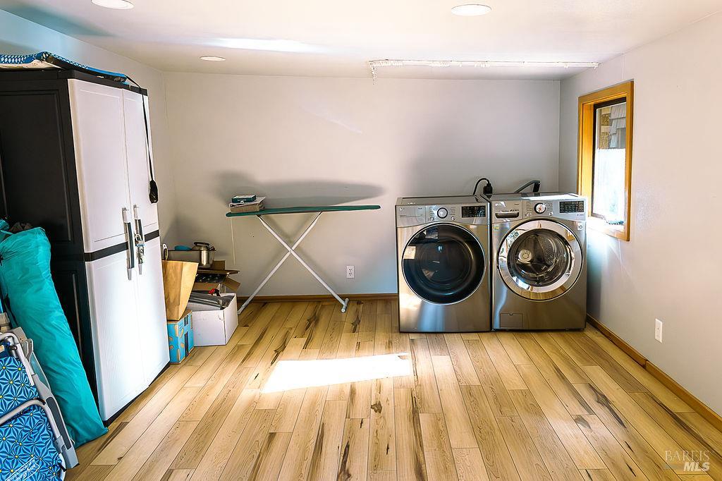 46151 Pacific Woods Road Gualala, CA 95445 - Photo 17 of 25 a utility room with wooden floor washer and dryer