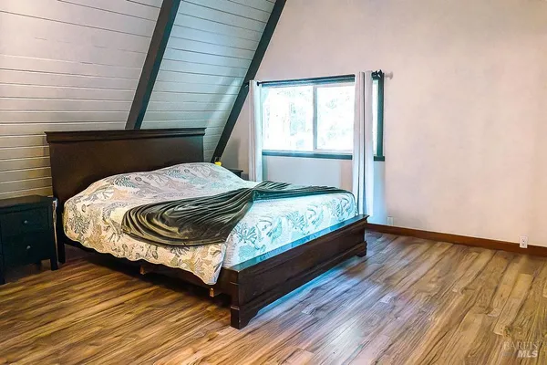 a bed sitting in a bedroom next to a window