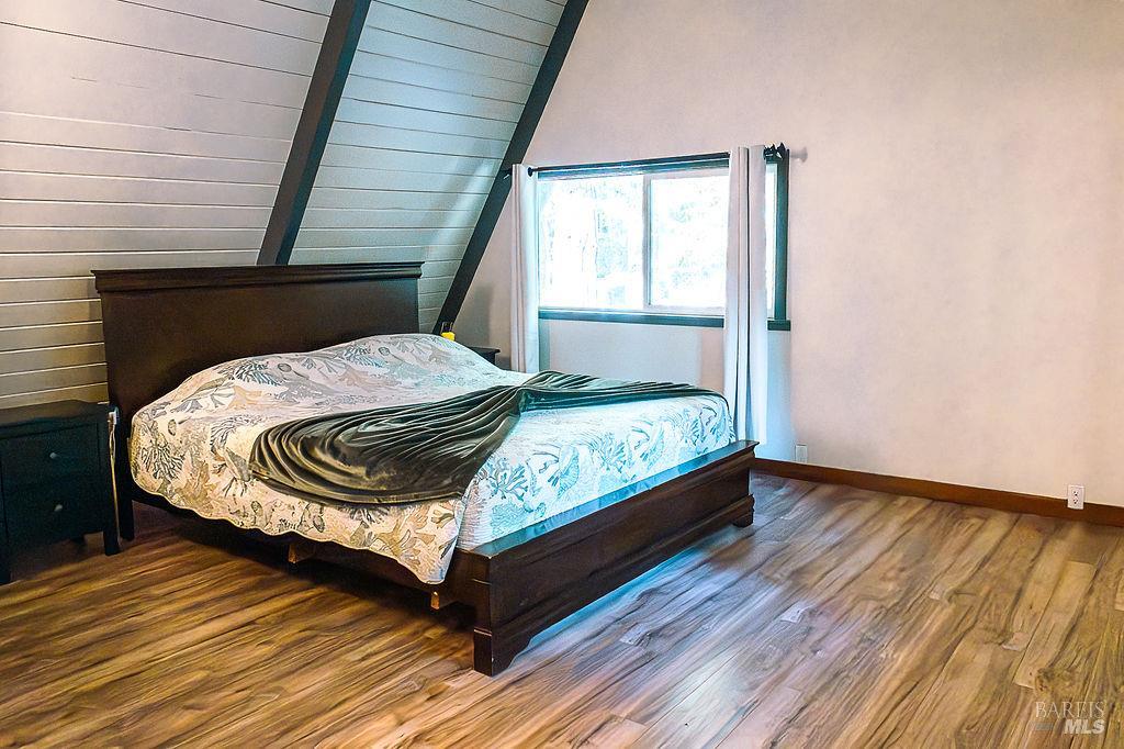 46151 Pacific Woods Road Gualala, CA 95445 - Photo 6 of 25 a bed sitting in a bedroom next to a window