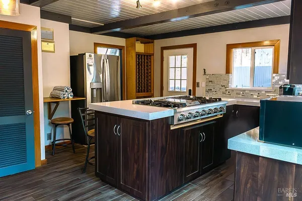 a kitchen with stainless steel appliances granite countertop a stove a sink dishwasher and a refrigerator