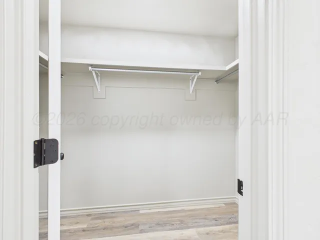 a view of walk in closet with clothes