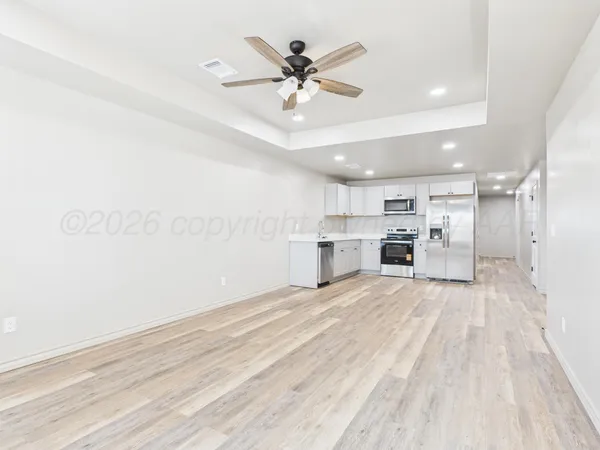 a view of kitchen with sink and refrigerator