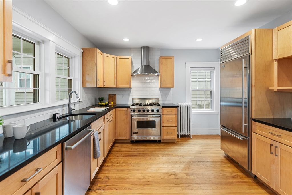 6 Appleton Place Arlington, MA 02476 - Photo 12 of 36 a large kitchen with stainless steel appliances granite countertop a stove and a sink