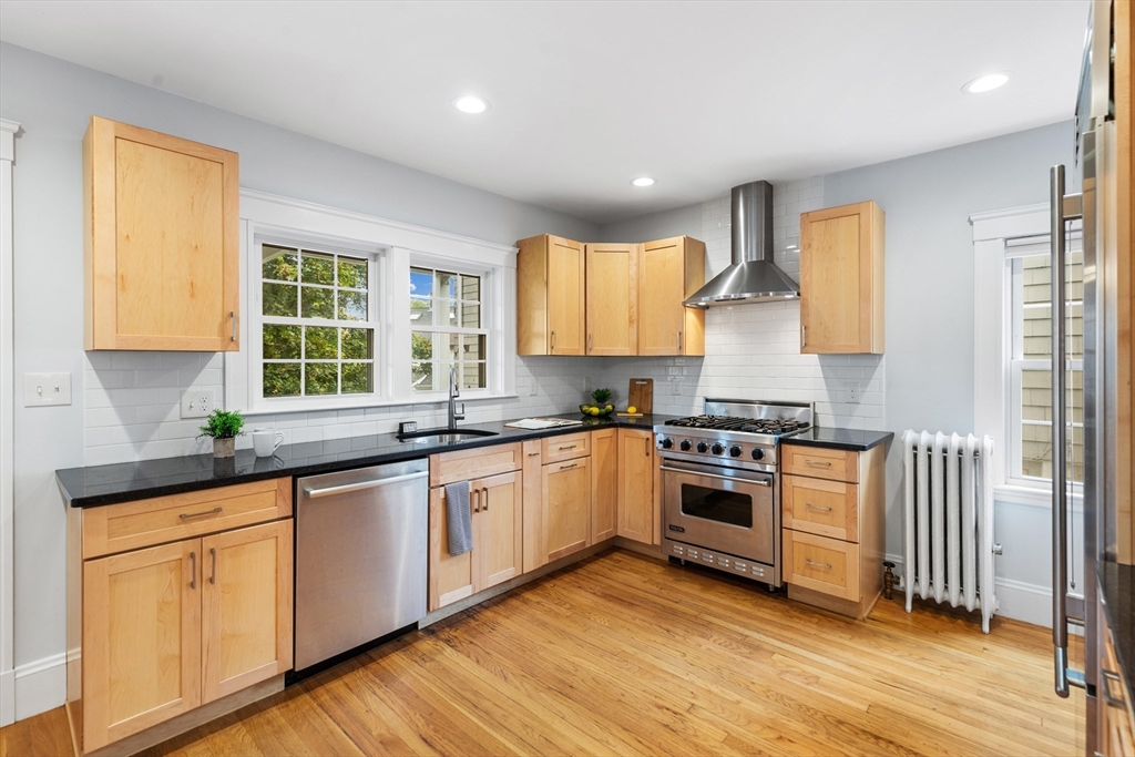 6 Appleton Place Arlington, MA 02476 - Photo 13 of 36 a kitchen with granite countertop white cabinets and wooden floor
