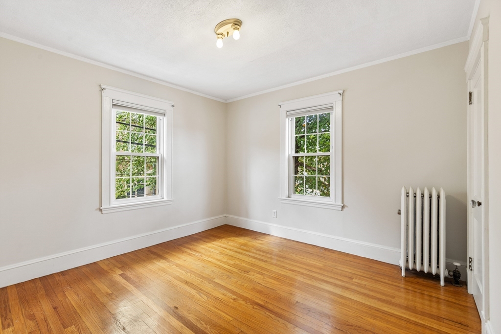 6 Appleton Place Arlington, MA 02476 - Photo 22 of 36 a view of an empty room with wooden floor and a window