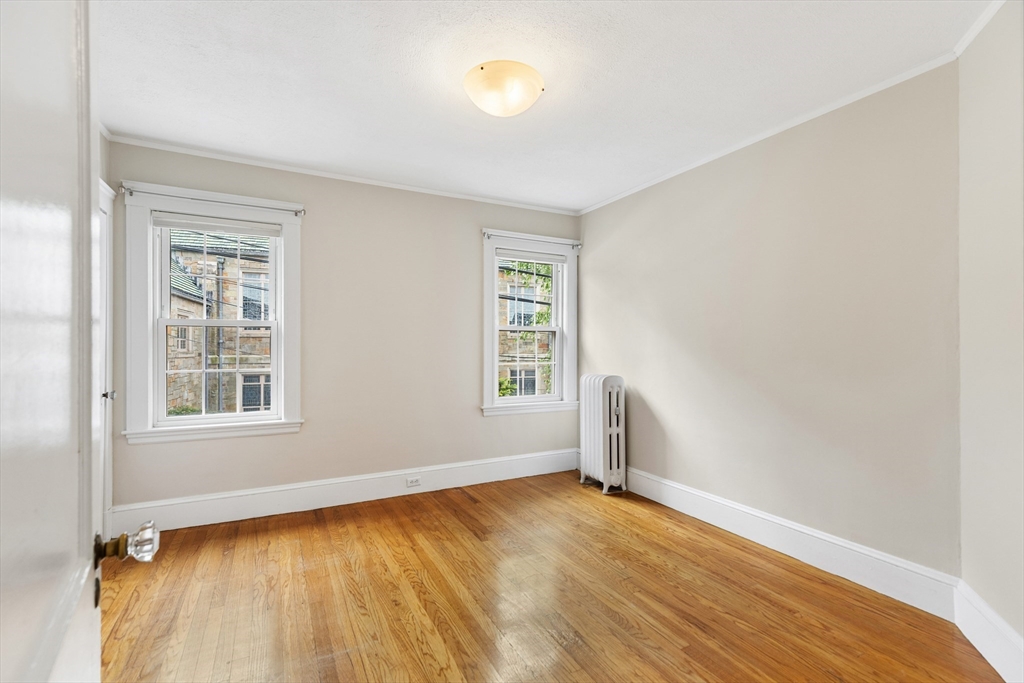 6 Appleton Place Arlington, MA 02476 - Photo 23 of 36 an empty room with wooden floor and windows
