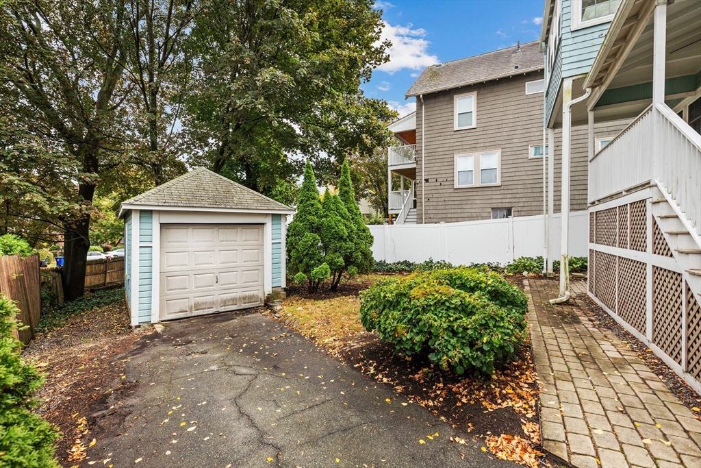 6 Appleton Place Arlington, MA 02476 - Photo 30 of 36 a front view of a house with a yard and garage