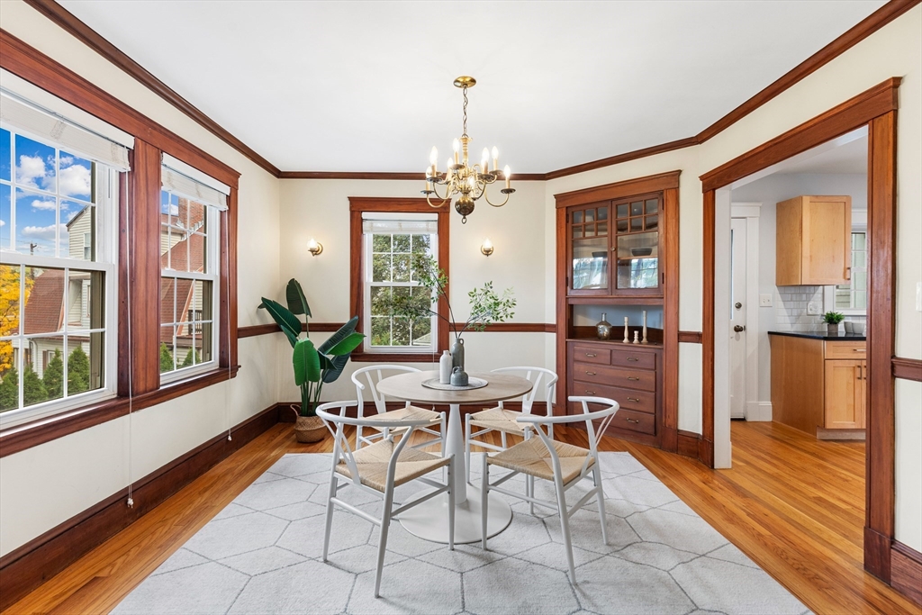 6 Appleton Place Arlington, MA 02476 - Photo 9 of 36 a dining room with furniture a chandelier and wooden floor