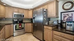 a kitchen with stainless steel appliances granite countertop a refrigerator a stove a sink and dishwasher