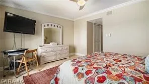 a bedroom with a bed and flat screen tv