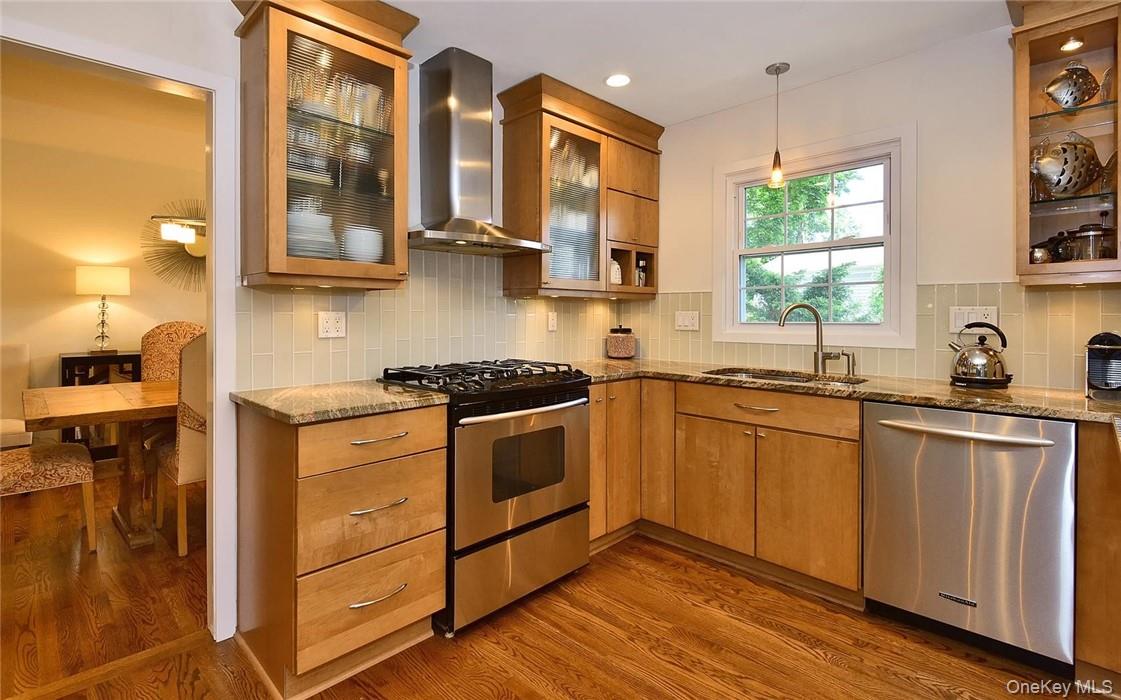 9 Franklin Avenue Rye, NY 10580 - Photo 11 of 35 a kitchen with stainless steel appliances granite countertop a sink and wooden cabinets
