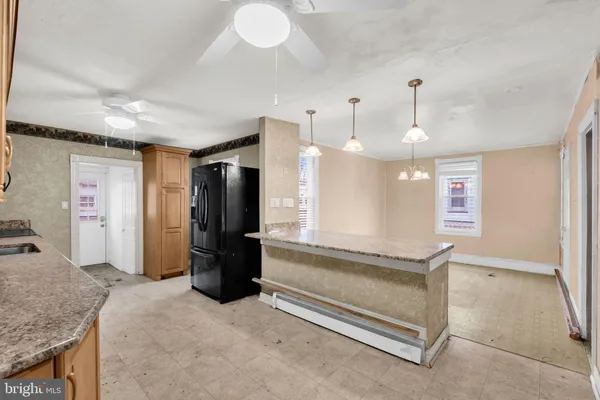 a kitchen with a refrigerator and a sink