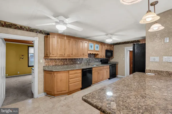 a kitchen with stainless steel appliances granite countertop a sink and cabinets