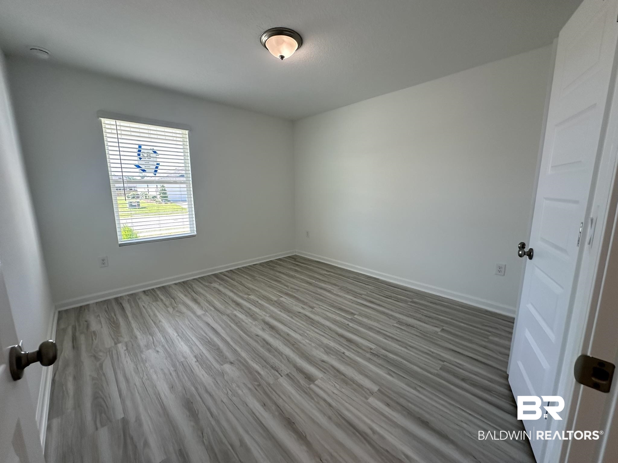 22227 Aleutian Avenue Foley, AL 36535 - Photo 9 of 64 Empty room with hardwood / wood-style flooring
