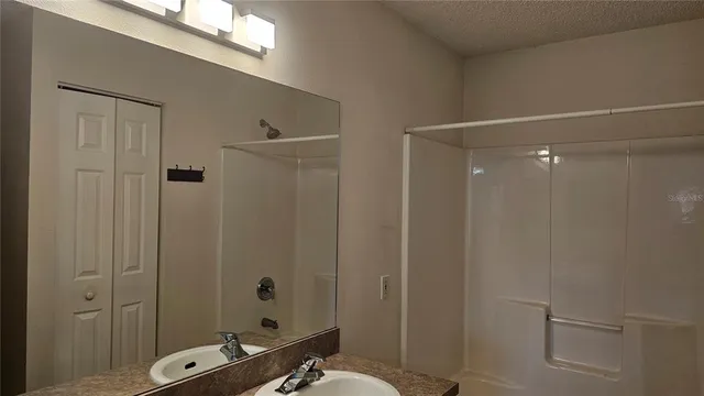 a bathroom with a shower a toilet and sink