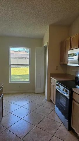 a kitchen with a stove a sink and a refrigerator