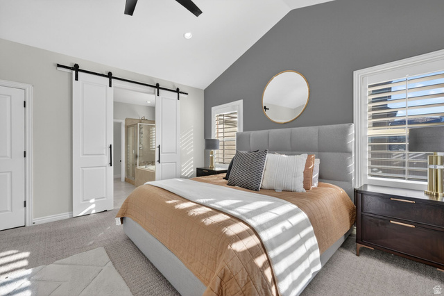 14738 Tangle Hill Road Herriman, UT 84096 - Photo 27 of 66 Vaulted ceiling bedroom featuring barn doors, plantation shutters, and recessed lighting
