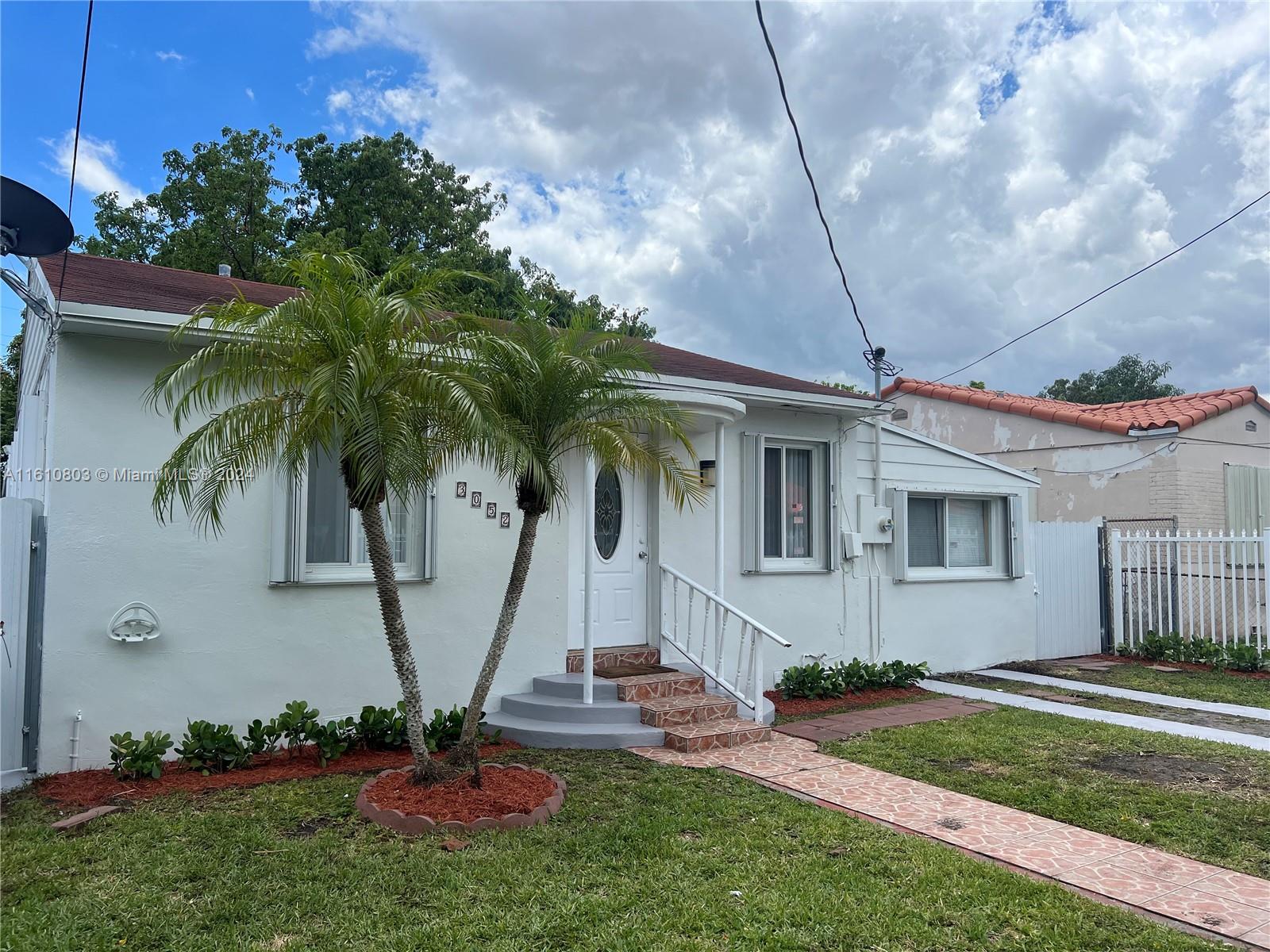 3052 Southwest 6th Street Miami, FL 33135 - Photo 3 of 17 a front view of a house with garden