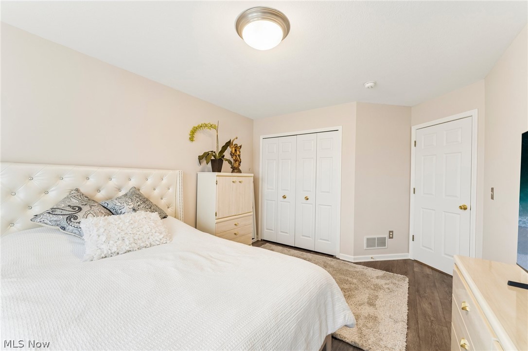8874 Sharp Road Olmsted Falls, OH 44138 - Photo 27 of 42 Interior room featuring wood-finish light-toned walls, a flush-mount ceiling light fixture, bi-fold closet doors, and a standard paneled door