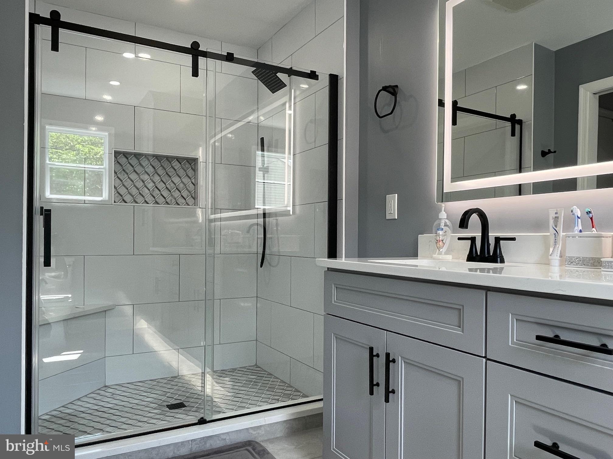 102 Springcress Drive Delran, NJ 08075 - Photo 37 of 50 a bathroom with a shower sink and mirror