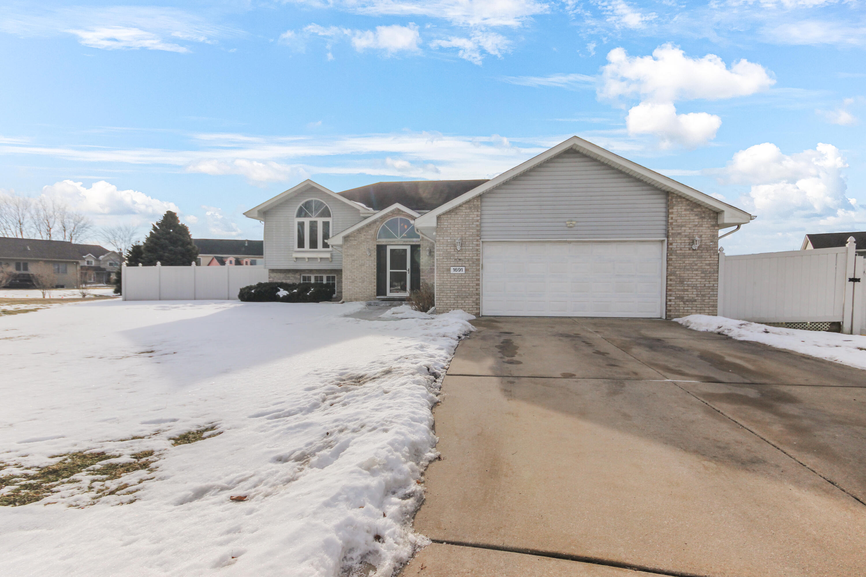 1691 Ruby Court Hobart, IN 46342 - Photo 24 of 27 a view of a house with a yard covered in snow
